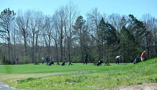 Golf sahasındaki insanlar Winder, Georgia, ABD 'deki golf sahasında golf toplarına vurmaya çalışıyorlar..