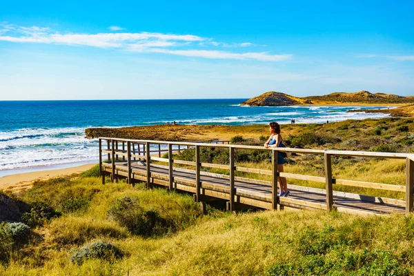 stock image Tourist woman walking relaxing on beach seashore, enjoying sunlight. Cala Magre in Calblanque Regional Park, Murcia region Spain.