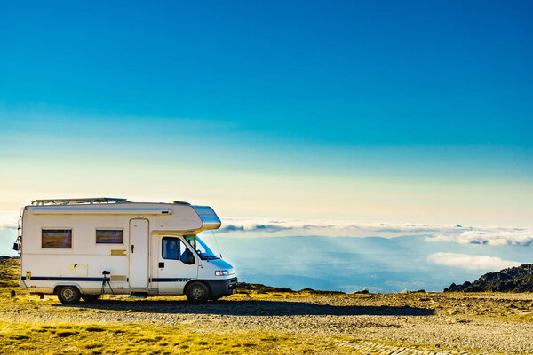 Caravan camping in mountains above clouds. Torre mountain peak of Serra da Estrela in Portugal. Adventure and holidays with mobile home.