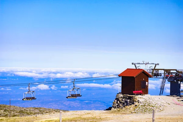 stock image Empty chair lift in high mountain above clouds. Torre mountain peak of Serra da Estrela.The highest place in Continental Portugal.