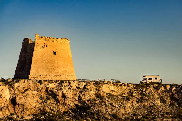 stock image Rv caravan at Mesa Roldan tower. Visiting Cabo de Gata Nijar Natural Park in Almeria province, Andalusia Spain. Tourist attraction, Defense towers.