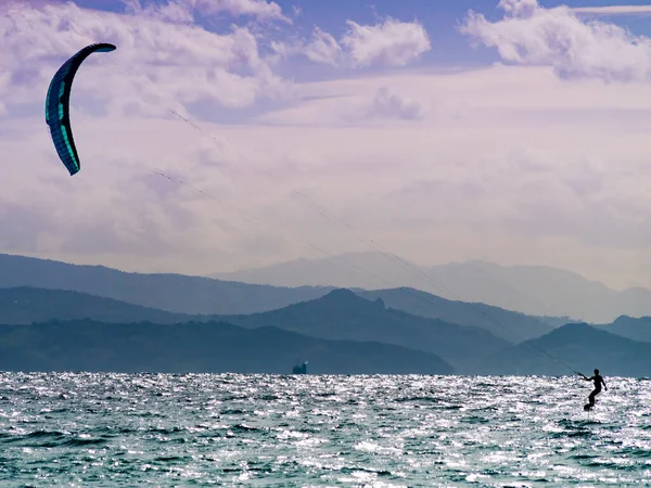 stock image Kiteboarding. Kite surfer rides waves, Tarifa, Cadiz in Spain. Sports activity. Kitesurfing action.