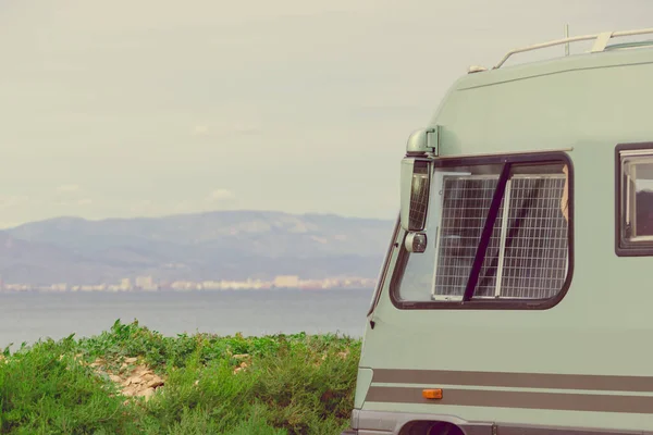 stock image Portable solar photovoltaic panel, charging battery in window pane of camper car rv. Electricity in holiday trip.