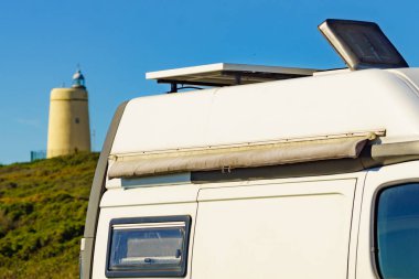 Caravan on mediterranean Costa del Sol coast at lighthouse Carbonera, La Alcaidesa, Spain. Vacation trip, travel in mobile home.