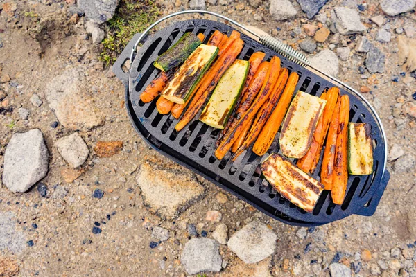 Assorted delicious grilled vegetables on barbecue grill, zucchini and carrot vegetable. Barbeque dinner outdoor.
