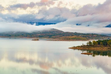 Sabah manzarası. İspanya 'nın kuzeyindeki Palencia, Kastilya ve Leon bölgesinde bulunan Kamboçya Gölü üzerindeki sis ve bulutlar..