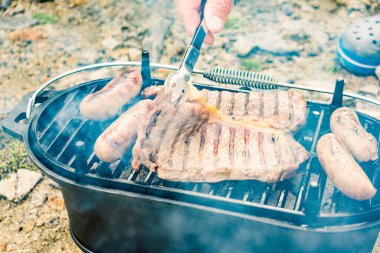 Et ve sosis ızgarada. Barbekü yemeği, yaz yemeği..