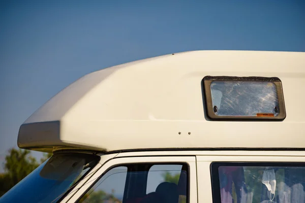 Camper van camping on nature in summer. Traveling by motor home. Caravan vacation.