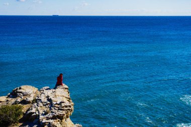 Tourist woman on spanish rocky coastline in Murcia region. Mediterranean Sea coast landscape, Calblanque Regional Park. clipart
