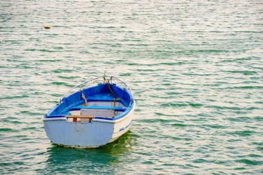 Mavi deniz suyunda demirli bir tekne