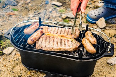 Et ve sosis ızgarada. Barbekü yemeği, yaz yemeği..