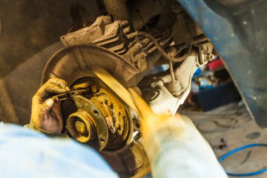 Araba serviste tamir ediliyor. Otomobilin tekerlek montajının ayrıntıları.