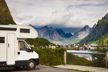 Yaz mevsiminde Reine köyü, Lofoten Norveç 'te karavan evi ve fiyort manzarası. Doğada kamp yapmak. Tatiller ve karavanla seyahat.