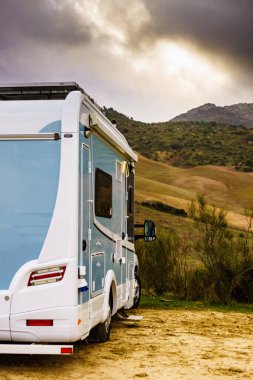 Camper vehicle camping in mountain nature. Holiday trip.