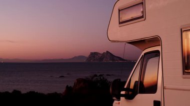 Sabah kumsalda karavan kampı, Punta Mala, Endülüs İspanya. Ufukta Cebelitarık kayası, İspanya kıyılarında İngiliz denizaşırı toprakları.