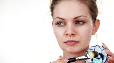 Yüzüne yeşil çamur maskesi dayayan genç bir kadın. Genç kız yağlı cildiyle ilgileniyor, gözenekleri temizliyor. Güzellik tedavisi. Cilt bakımı.