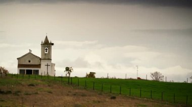 Evora, Portekiz 'deki Luz köyünde küçük bir kilisenin üzerinden geçen şiddetli yağmur bulutları..