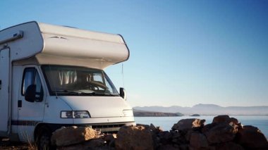 Kamp aracı deniz kenarında kamp yapıyor. Karavanla seyahat ediyorum. Karavan tatili. Doğa ve faaliyetler.