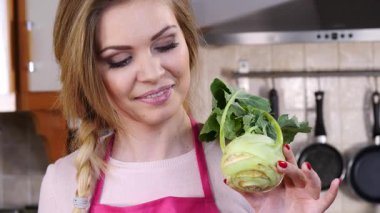 Elinde çiğ sebze kohlrabi lahanası tutan mutlu genç kadın. Doğal organik sağlıklı gıda konsepti.