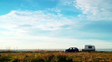 Deniz kıyısında kamp yapan karavan karavanıyla birlikte kıyı arazisinde bulutların hızlanması. Capicorb, Valencia bölgesi İspanya. Gezici evle tatil.