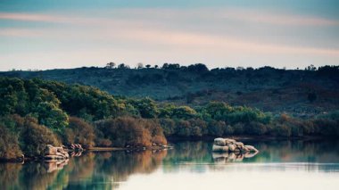 Akşam gölü manzarası. Suyun üzerinde hareket eden bulutların zamanı, ışığın kararması. Povoa e meadas dam in castelo de vide, alentejo Portekiz.