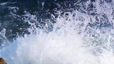 Büyük dalgalar kayalıklara çarpıyor. Ağır çekim. Yukarıdan görüntüle