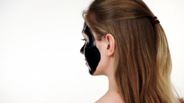 Yüzünde, beyaz karbonhidrat temizleme maskesi olan genç bir kadın. Genç kız yağlı cildiyle ilgileniyor, gözenekleri temizliyor. Güzellik tedavisi. Cilt bakımı.