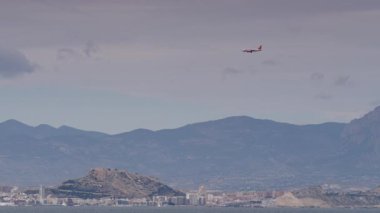 Alicante, valencia, İspanya - 13 Aralık 2019: costa blanca kıyı şeridi deniz kenarı alacant şehri ve uçak İngiliz hafif jeti uçuş halinde. Seyahat.