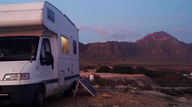 Gece yarısı karavanın sahilinde kamp yapan karavanın üzerine düşüyor, karavanın içi aydınlanıyor. Karavanla seyahat ediyorum. Doğa ve faaliyetler.