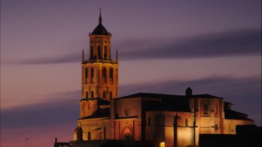 Night view of collegiate church nuestra senora de la asuncion in santa maria del campo town, province of burgos, spain. Timelapse