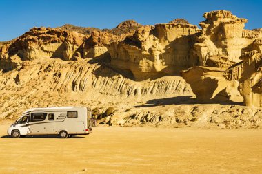 Aşınmış sarı kumtaşı oluşumlarındaki park yerinde kamp arabası, Büyülü Şehir Bolnuevo, Murcia İspanya. Turist eğlencesi.