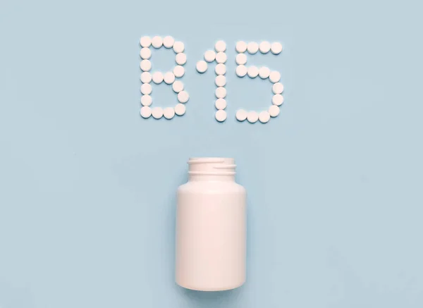 Vitamin B15, Pangamic acid icon from tablets and drug bottle on blue background. Colltction of vitamin and minerals