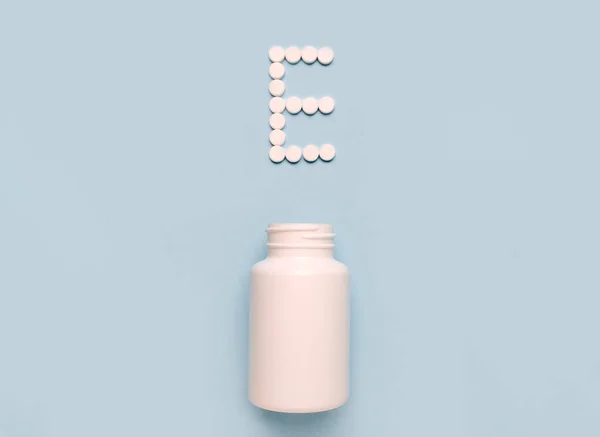 Vitamin E tocopherol  icon from tablets and drug bottle on blue background. Colltction of vitamin and minerals