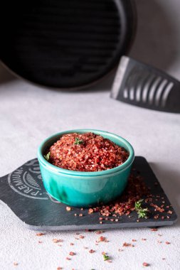 A bowl with homemade red wine infused salt. Condiment to aromatize and season food