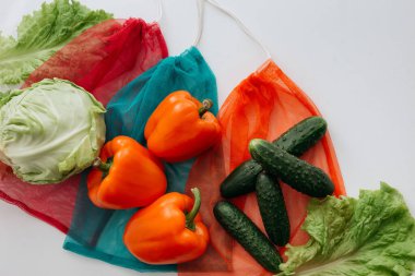 eco-bags with vegetables on a white background