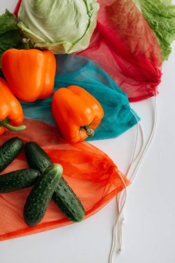 eco-bags with vegetables on a white background