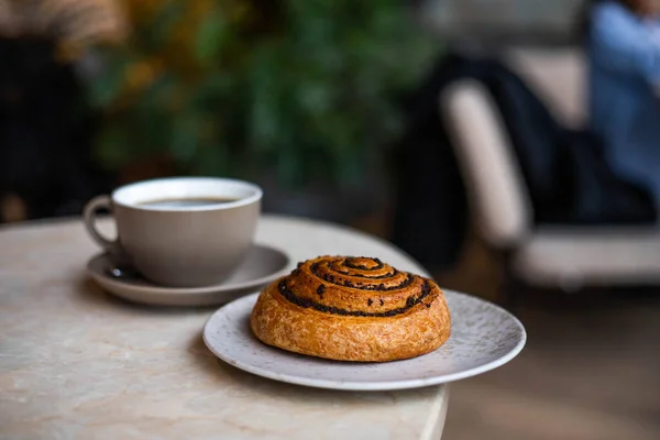 delicious pastries with poppy seeds and a mug of coffee