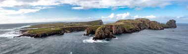 The cliffs and sea stacks An Tor Mor and the Wishing Stone at Port Challa on Tory Island, County Donegal, Ireland.