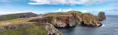 The cliffs and sea stacks An Tor Mor and the Wishing Stone at Port Challa on Tory Island, County Donegal, Ireland.