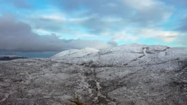 Flying towards Croloughan Lough next to the snow covered Mount Errigal, the highest mountain in Donegal - Ireland