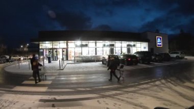 DUNGLOE, COUNTY DONEGAL, IRELAND - JANUARY 16 2023 : People are shopping during the snow fall.