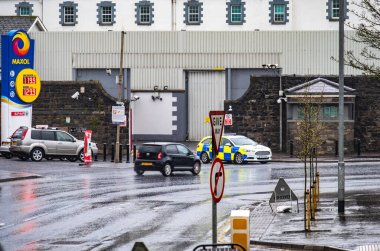 ENNISKILLEN, ULSTER, NORTHERN IRELAND - MARCH 03 2019 : The Kesh police station is protected by a huge fence a couple of days before the Brexit. clipart