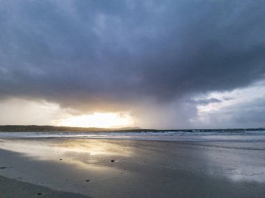 Dramatic clouds above Narin Strand, a beautiful large blue flag beach in Portnoo, County Donegal - Ireland clipart