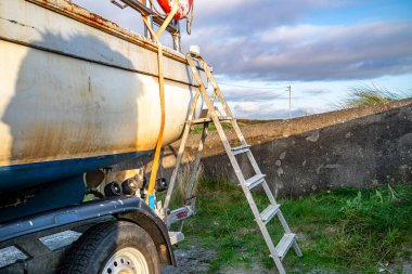 COUNTY DONEGAL, IRELAND - NOVEMBER 09 2021 : The fishing vessel is waiting on the dry dock for the next season. clipart