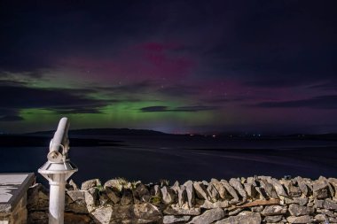 The Aurora Borealis, the northern lights, showing up in Portnoo, County Donegal, Ireland clipart