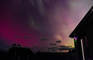 Aurora Borealis, Kuzey Işıkları, İrlanda 'nın Donegal ilçesinde bungalovun üstünde beliriyor..