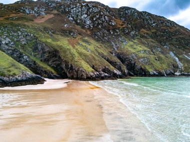 Aerial view of the beach and caves at Maghera Beach near Ardara, County Donegal - Ireland clipart