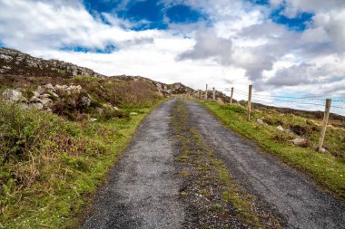 The coastal single track road between Meenacross and Crohy Head south of Dungloe, County Donegal - Ireland. clipart