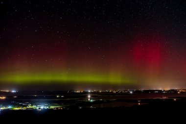 The Aurora Borealis, the northern lights, showing up above Maghery, Burtonport, Arranmore and Dungloe in County Donegal, Ireland clipart