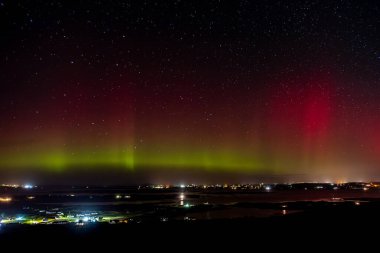 The Aurora Borealis, the northern lights, showing up above Maghery, Burtonport, Arranmore and Dungloe in County Donegal, Ireland clipart